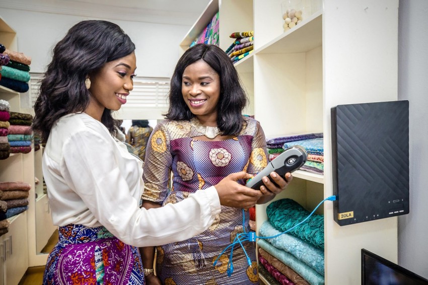 ZOLA FLEX Africa Nigeria Lagos Urban SME Fabric Shop Customer Client Charging POS Machine on Solar Shoot 403